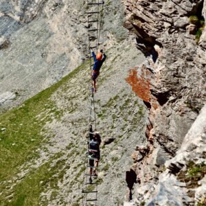 Climbers on a via ferrata ladder in the mountains